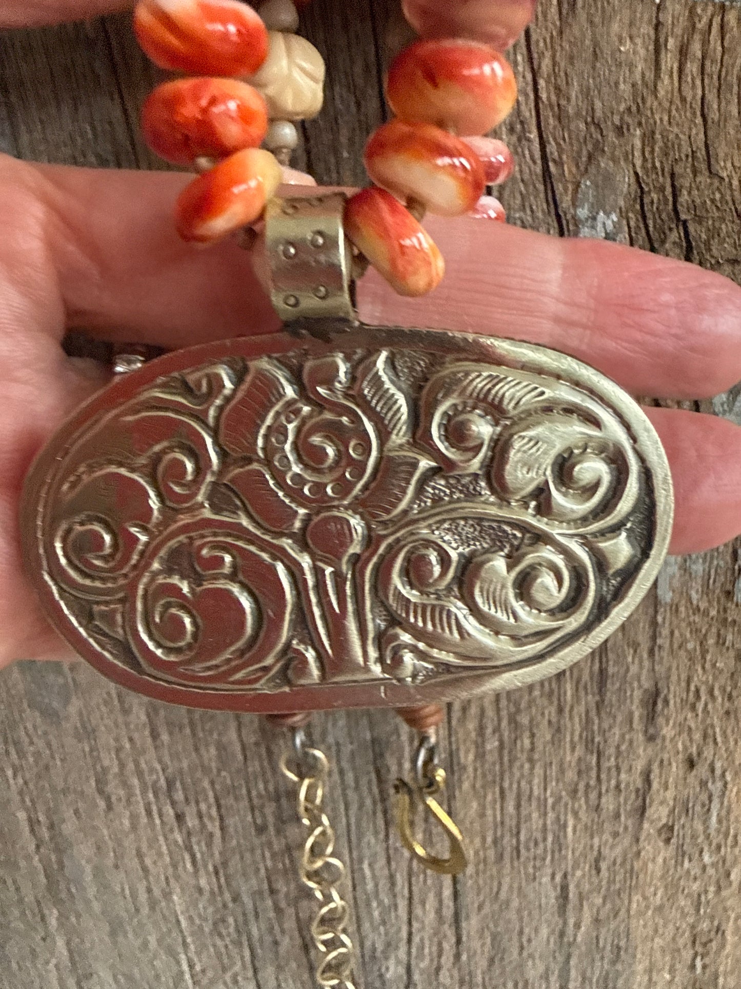 Tibetan carved bone flower pendant on spiny oyster necklace. 16-19”