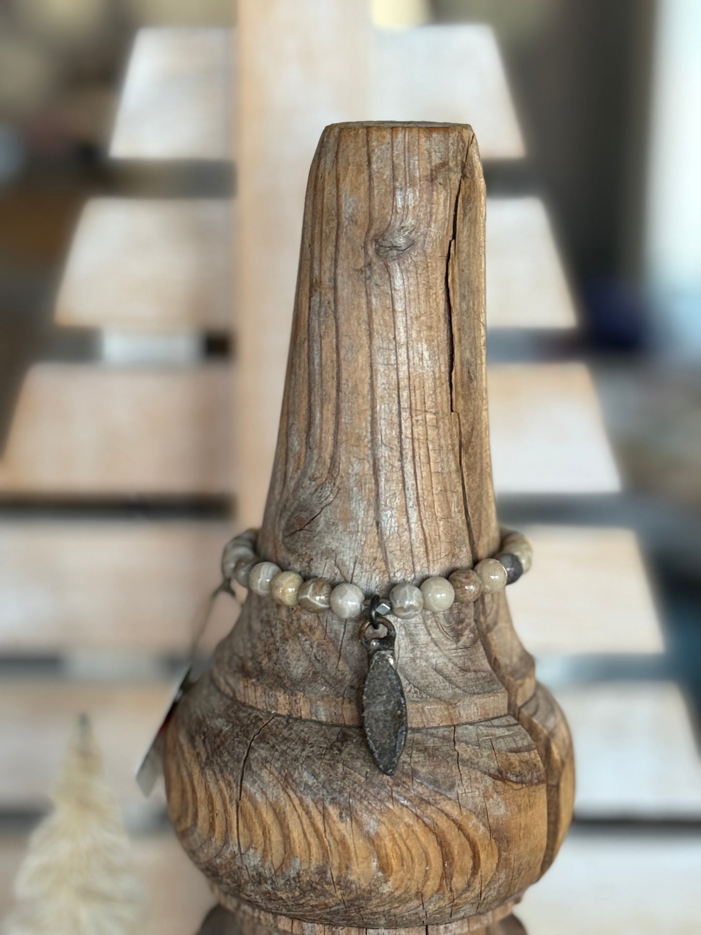 Smoky quartz druzie hangs from a stack bracelet of fossil coral beads 6.5-7”.