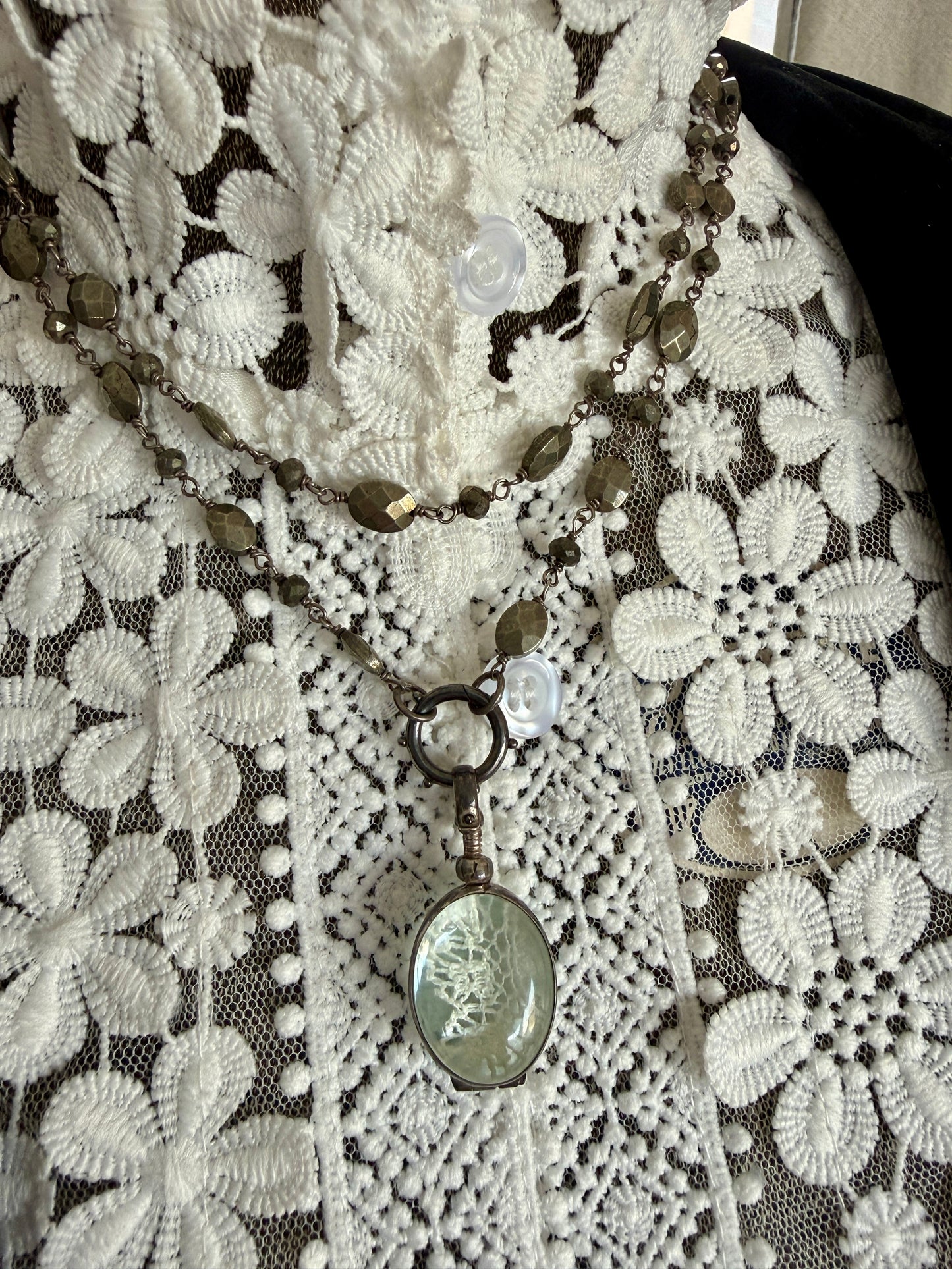 Antiqued sterling locket on faceted pyrite chain. 34” long necklace.