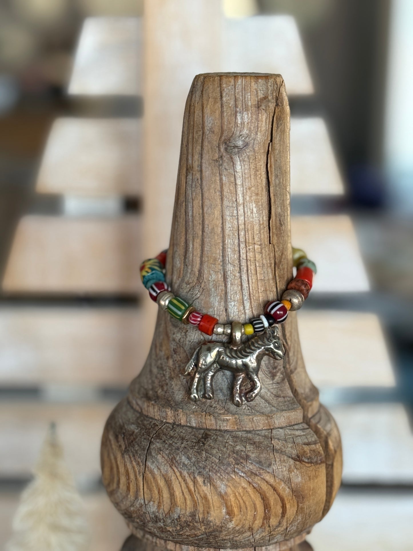 Donkey charm on a mix of gems, trade beads, and Ethiopian silver stretch bracelet. 6.5”