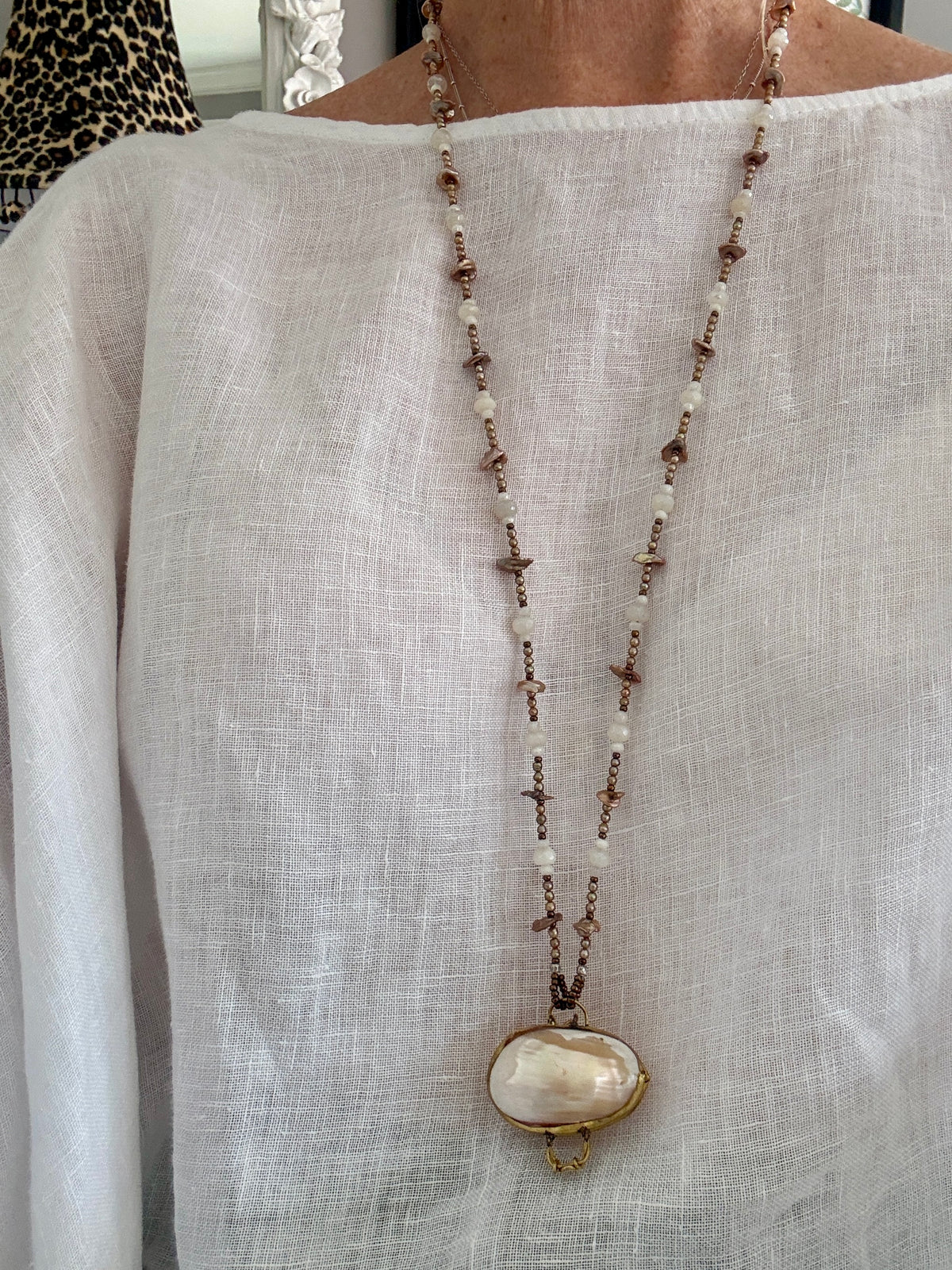 A vintage handcrafted shell ring box pendant with champagne pearls and moonstone long necklace.