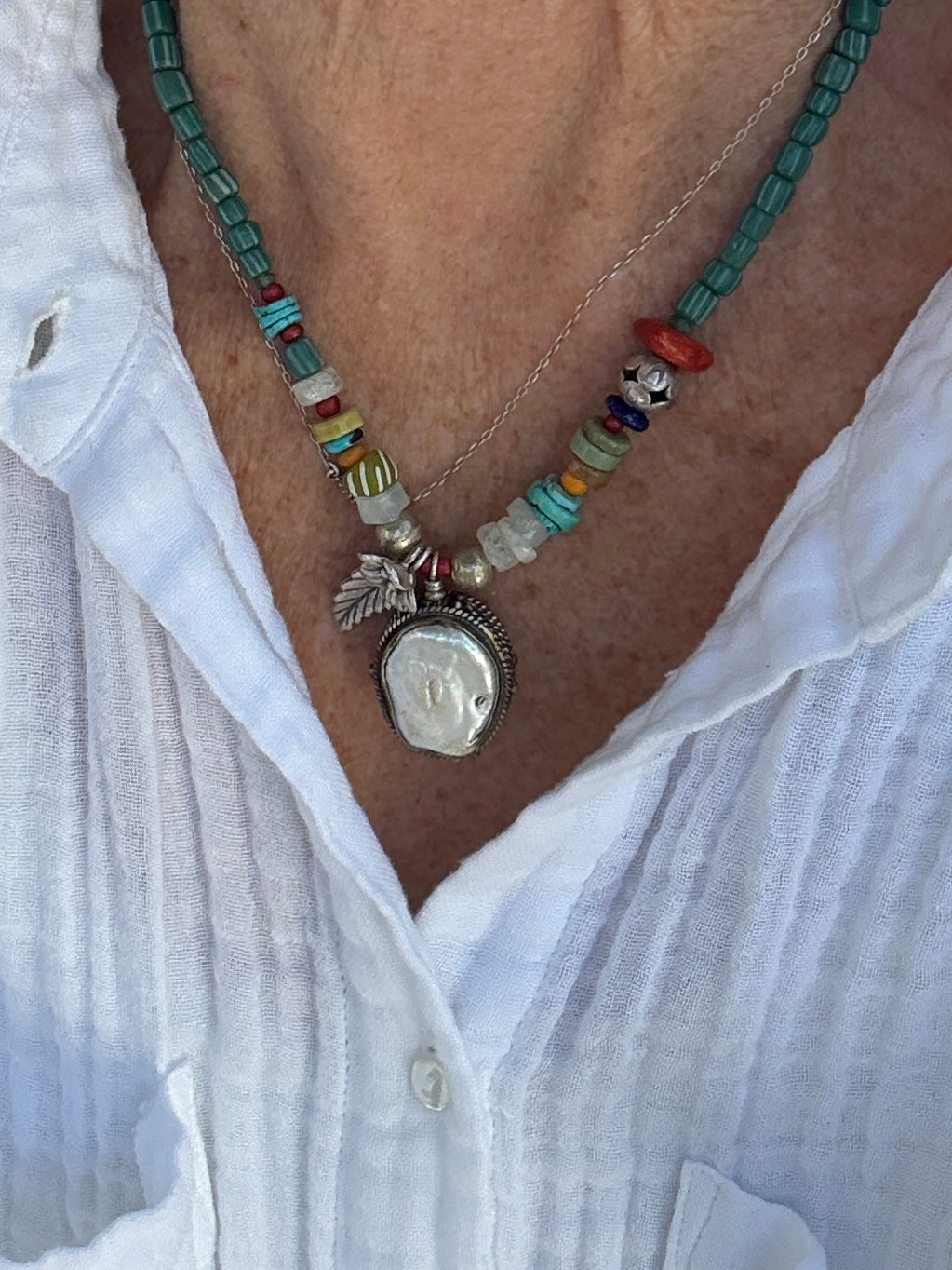 Pearl pendant on trade beads, moonstone, turquoise, coral, and fine silver accents necklace. 17.5”