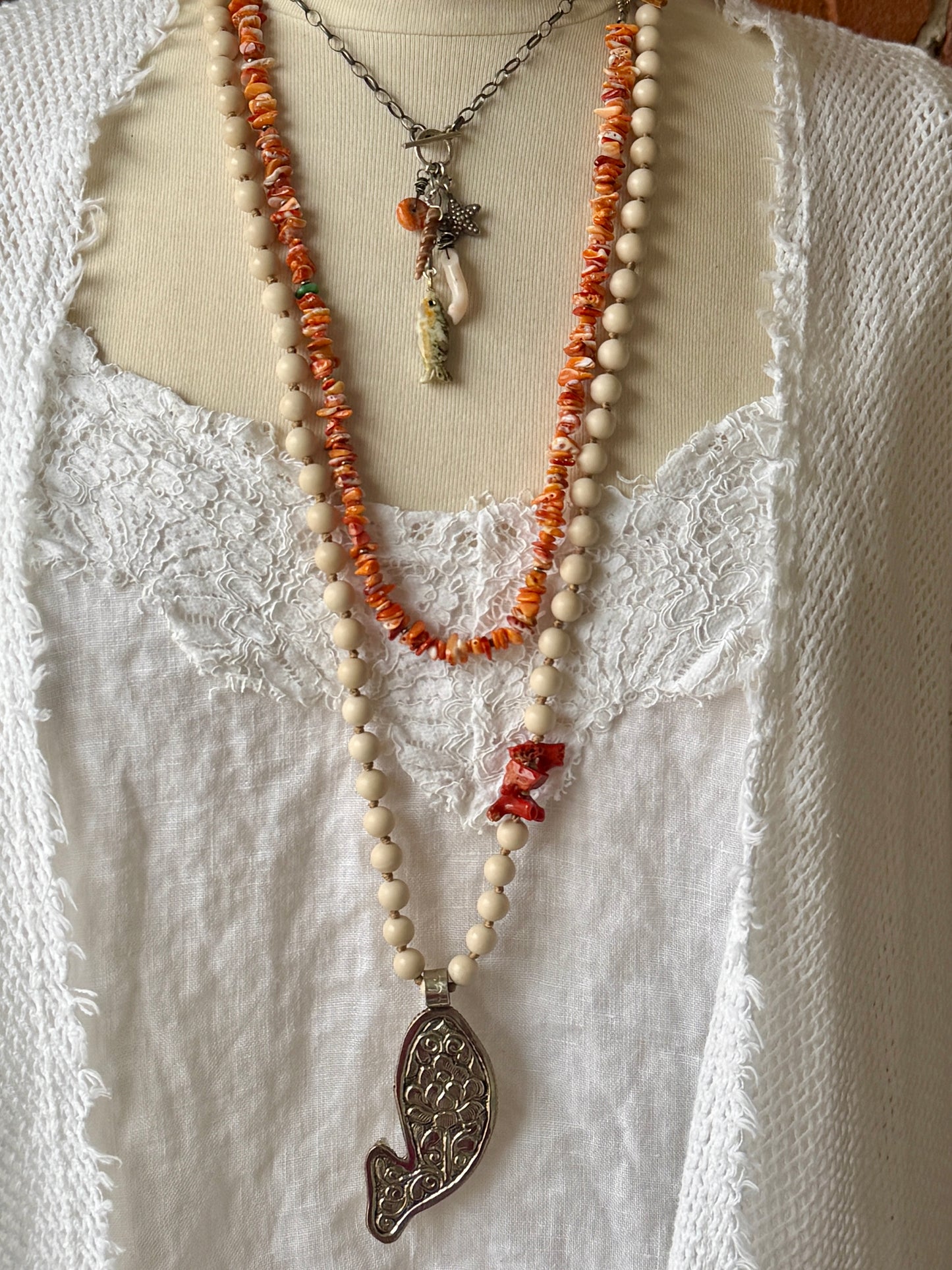 Oxidized sterling chain necklace with front toggle, bumblebee jasper fish, fine silver starfish, white coral, shell, and spiny oyster danglies.