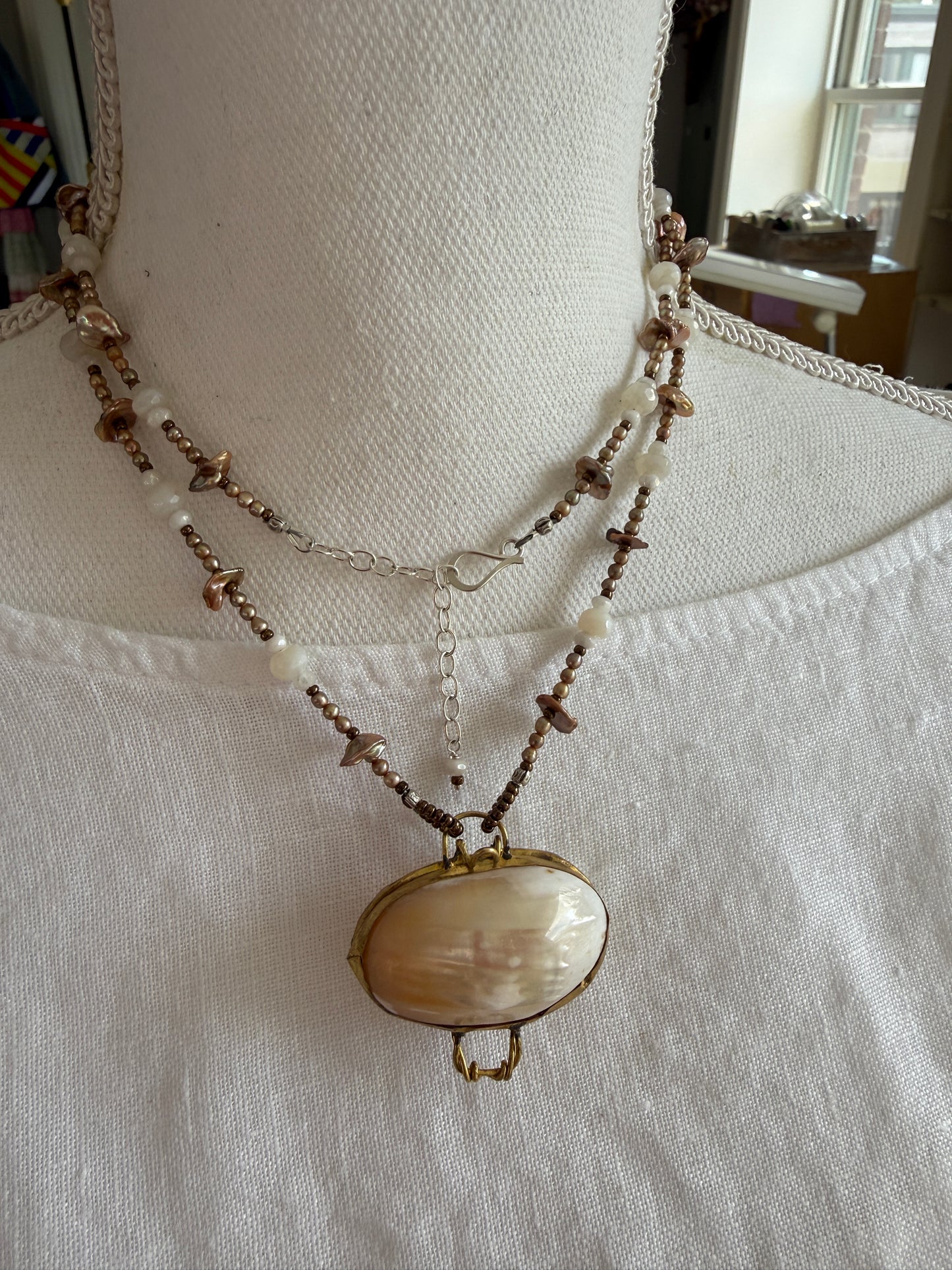 A vintage handcrafted shell ring box pendant with champagne pearls and moonstone long necklace.