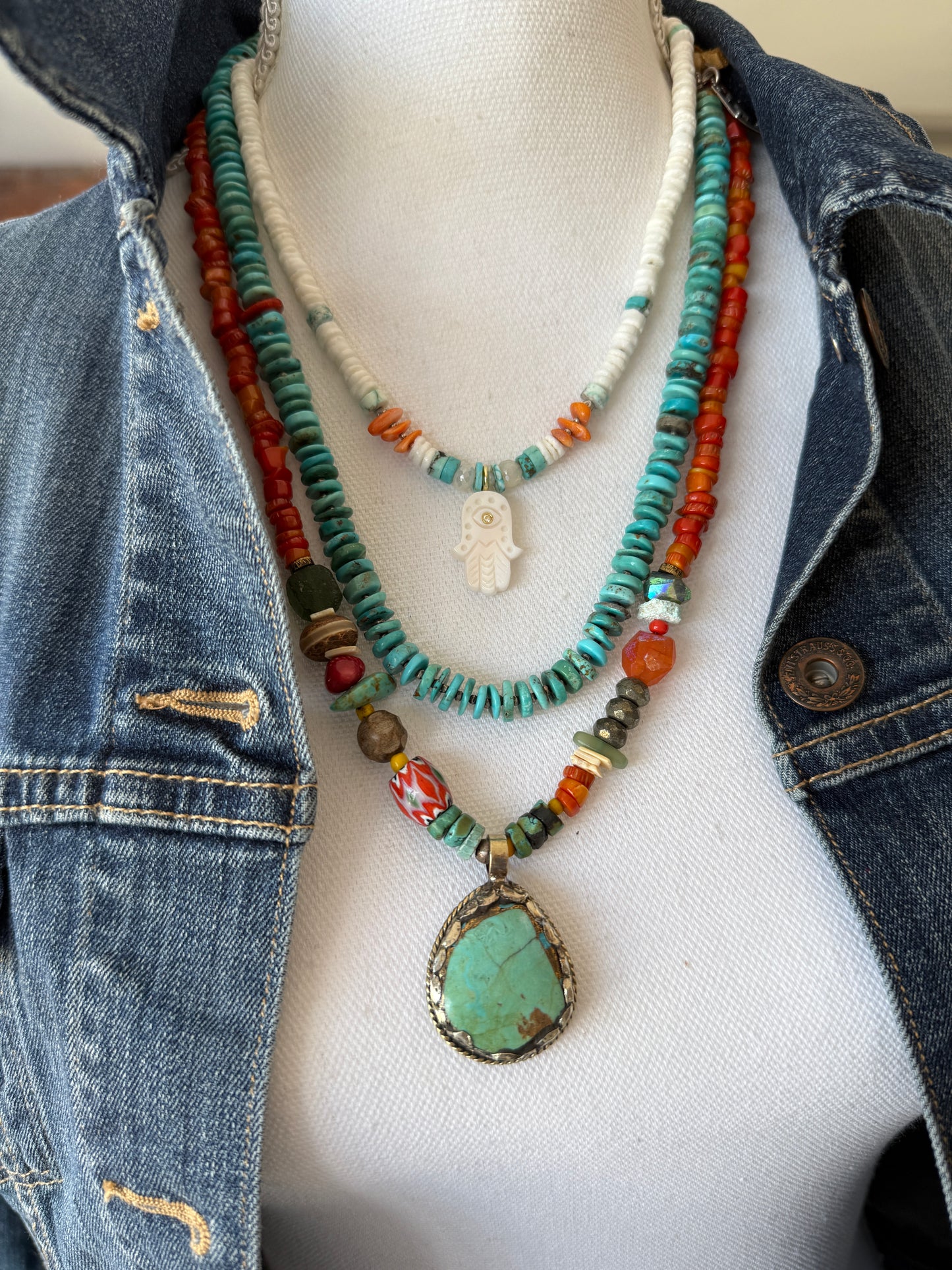 Mother of pearl and diamond hamsa on turquoise, coral, moonstone, and bone. Adjustable 17-19”