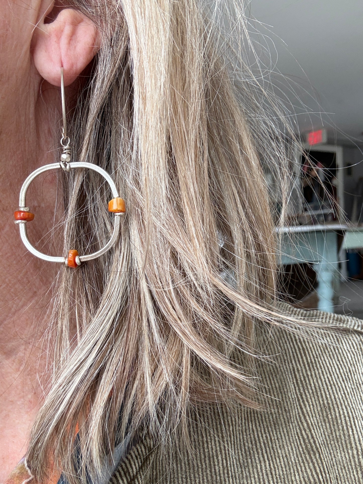 Segmented hoops of fine silver with broom coral accents earrings.