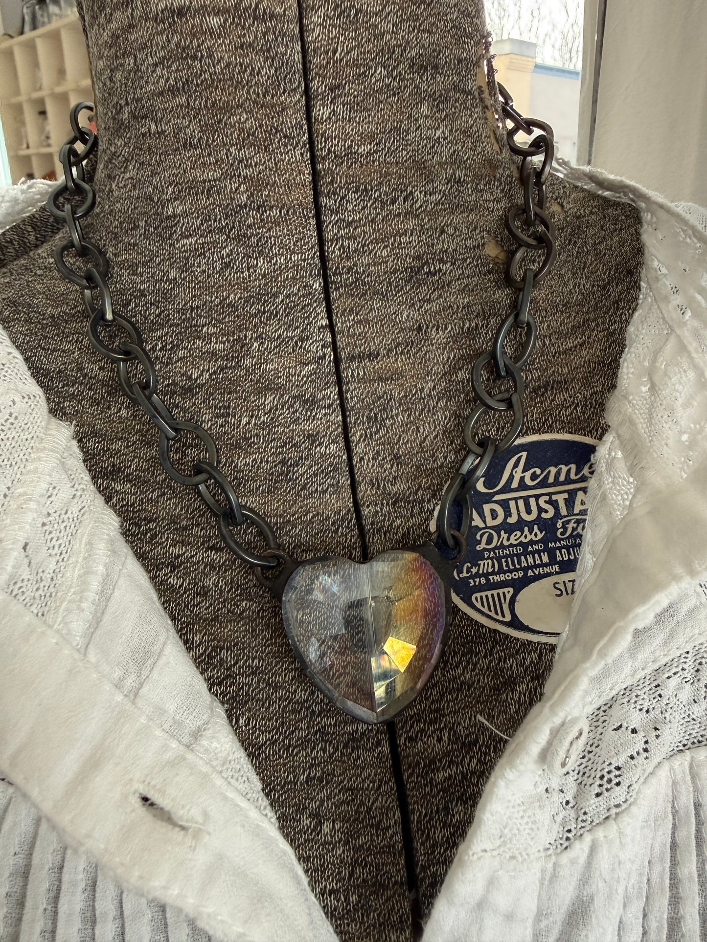 Prism crystal heart on gunmetal base metal chain necklace.