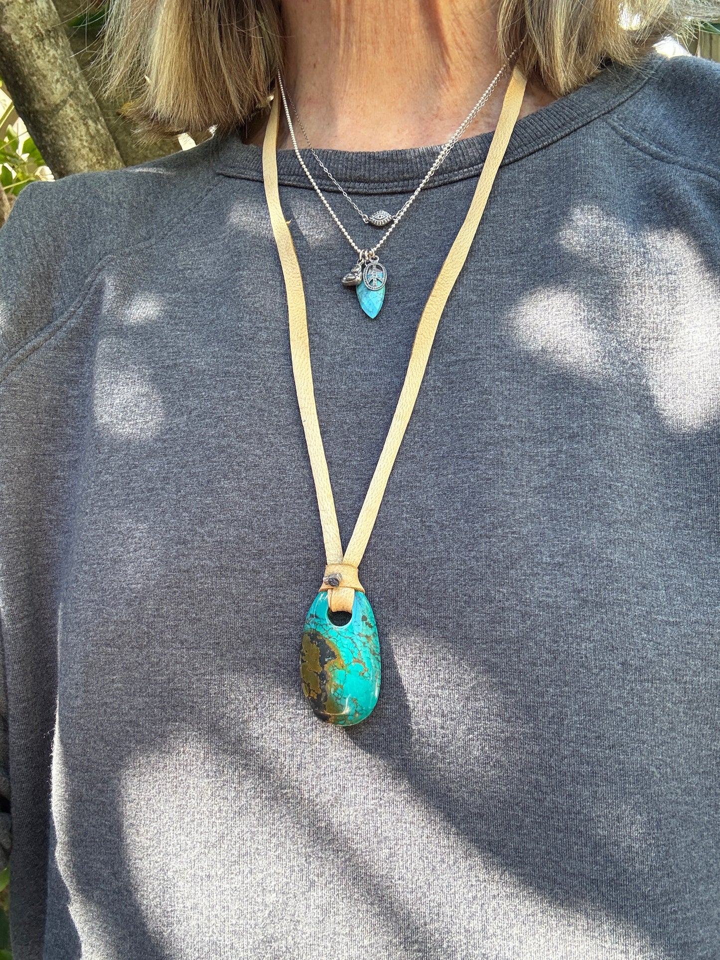 Turquoise spear with sterling Buddha and peace charms on sterling ball chain necklace. 18”