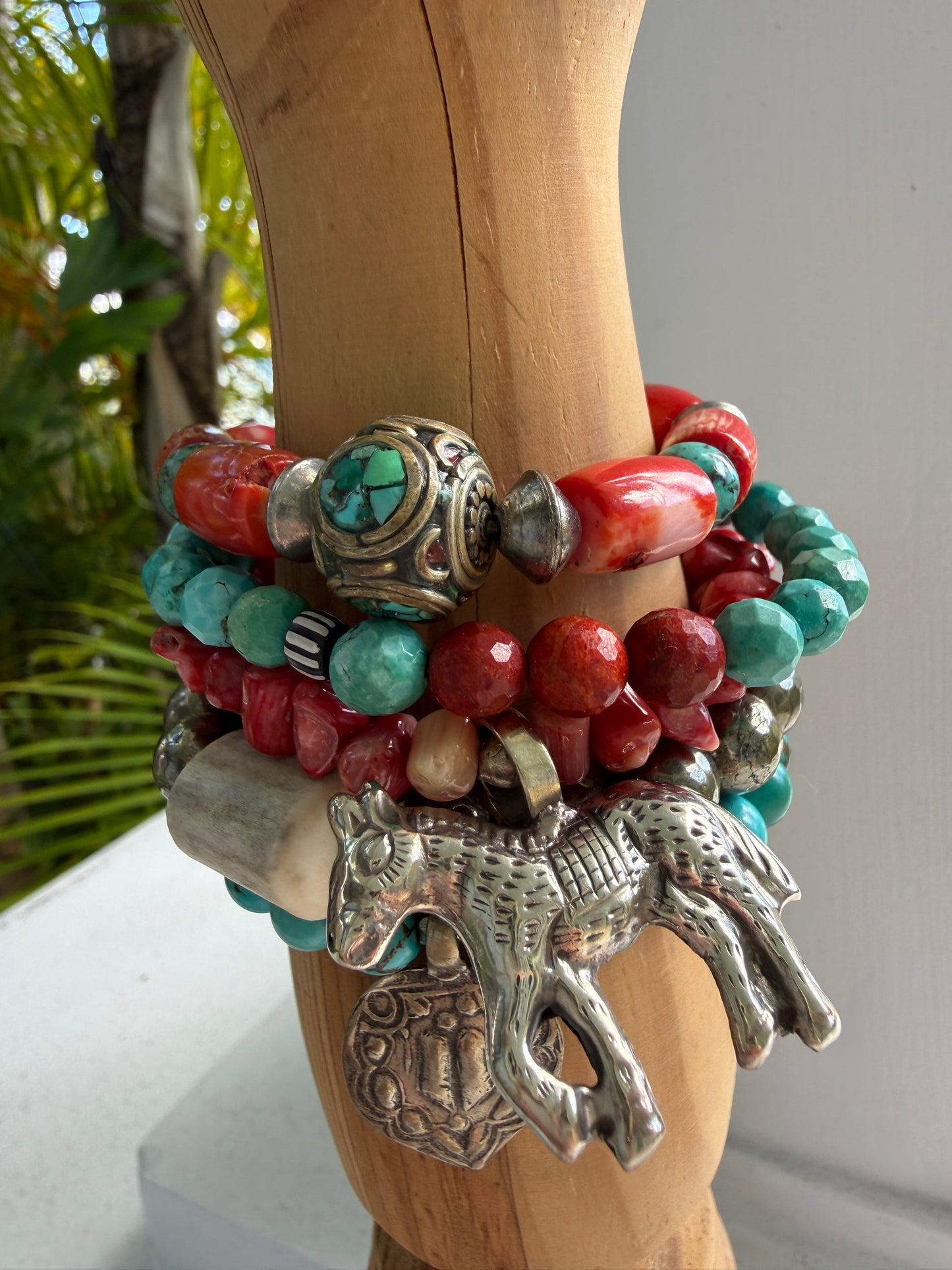 Old Tibetan bead with turquoise inlay surrounded by coral and turquoise beads stretch bracelet. 7”