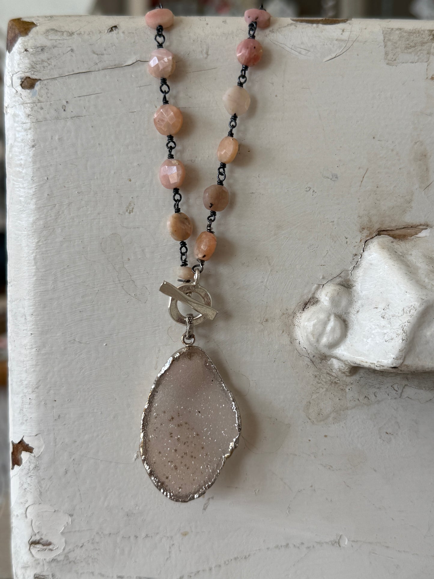 Pale pink druzie on pink Peruvian Opal wire-wrapped coins. Front fine silver toggle necklace.