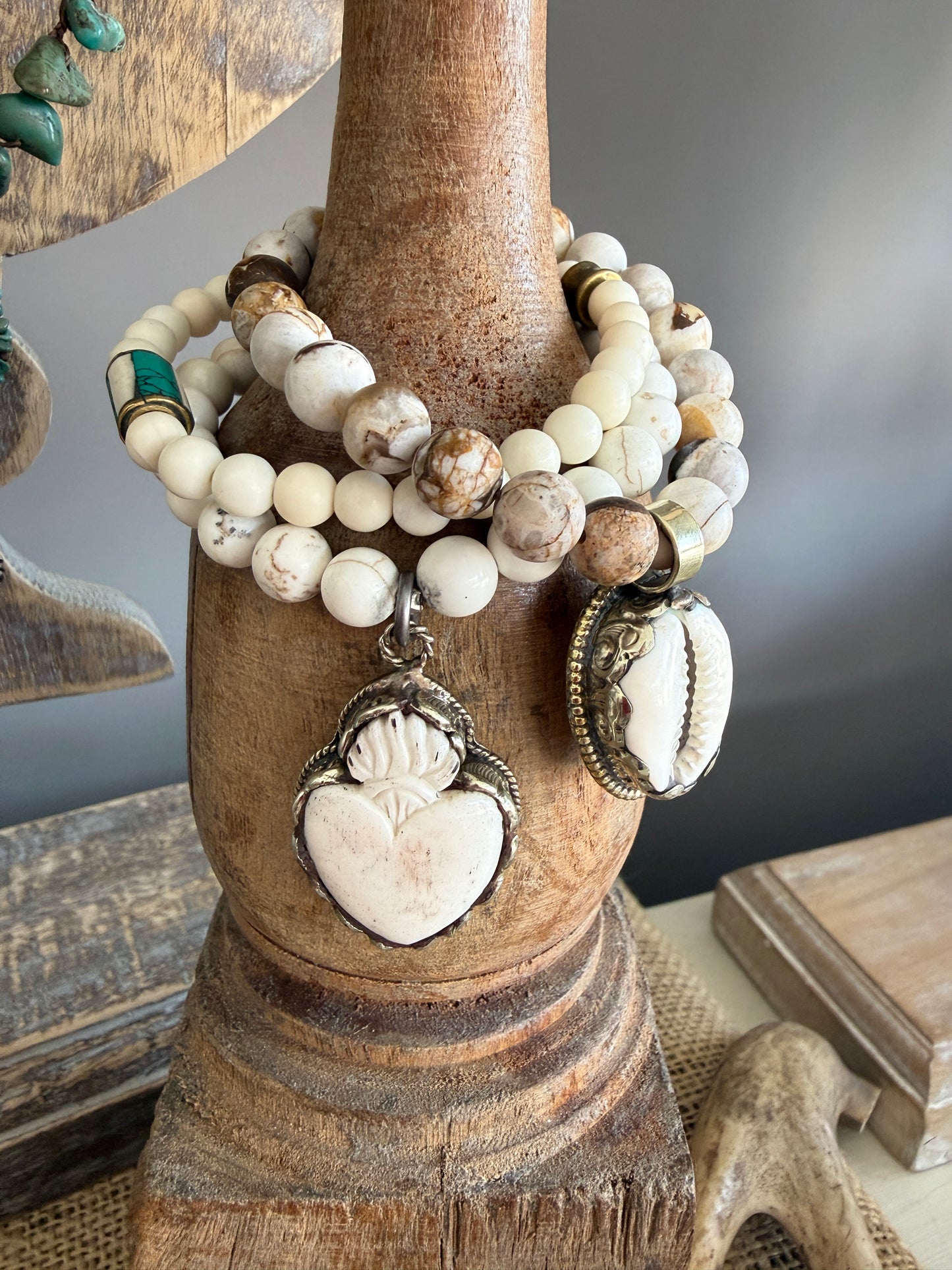 White riverstone stretch stack bracelet with turquoise and bone inlay bead from Nepal. 6.5”