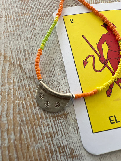 Citrus mix seed beads from Java dance around a stamped Thai half moon. So cute on its own or when layered up with other ladeDAH! pieces.