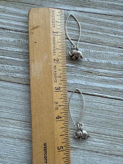 Fine silver elephant earrings on elliptical sterling ear wires.