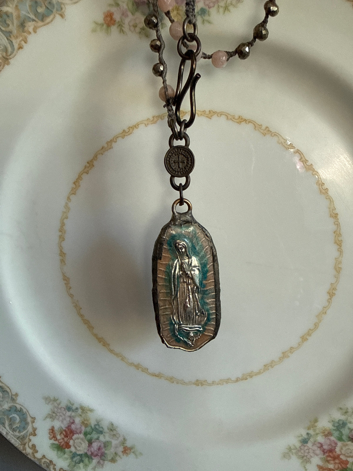 Our Lady of Guadeloupe pendant on knotted sunstone necklace.