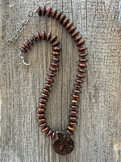 A natural ammonite fossil and chocolate brown button pearl necklace.