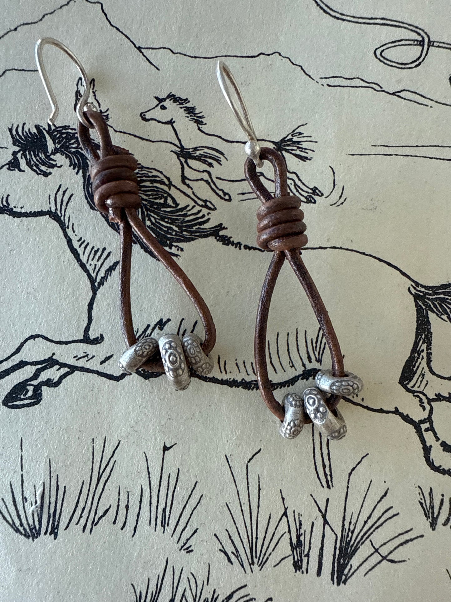 Leather and fine silver earrings.