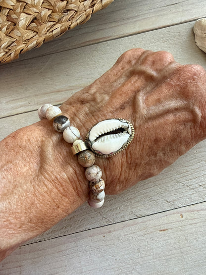 Wood opal and Tibetan cowrie shell charm with repousé back stretch stack bracelet. 6.5-7”