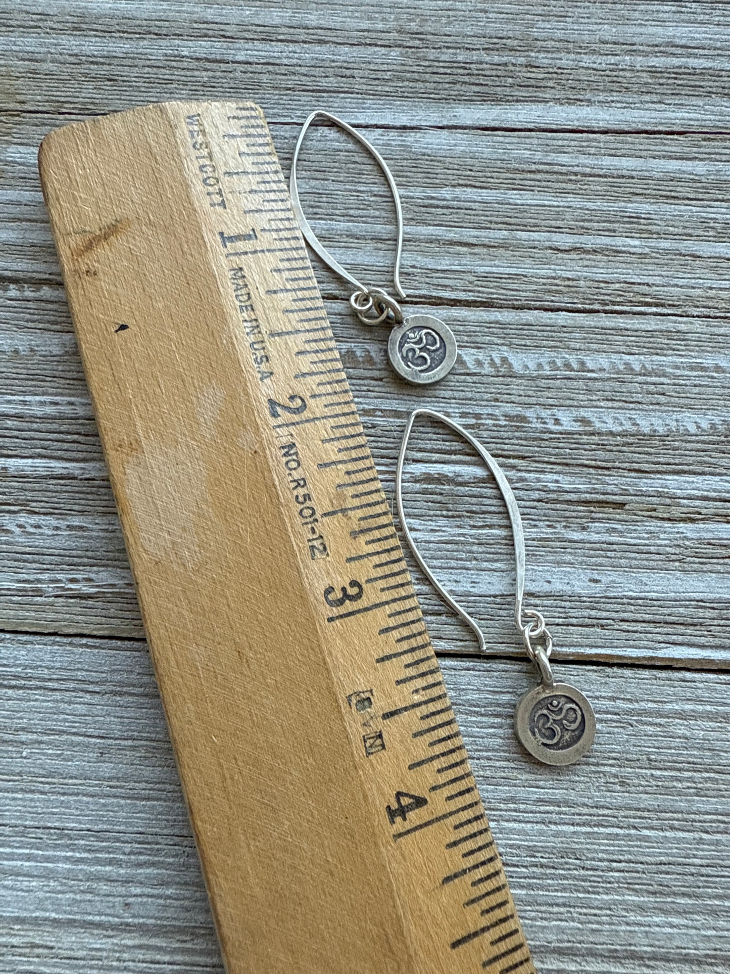 Fine silver ohm earrings on fine silver wires.