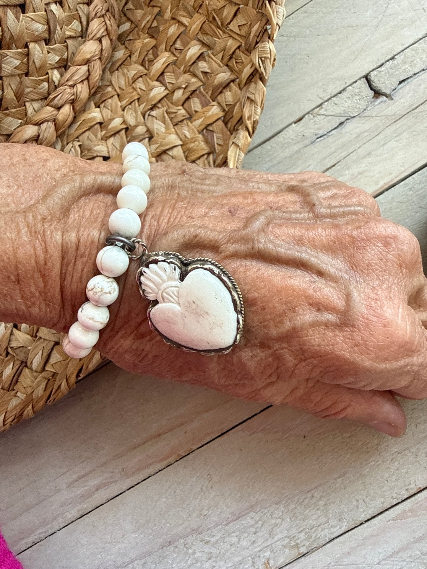 Bone flaming heart pendant on peach blossom agates stretch stack bracelet. 7”.