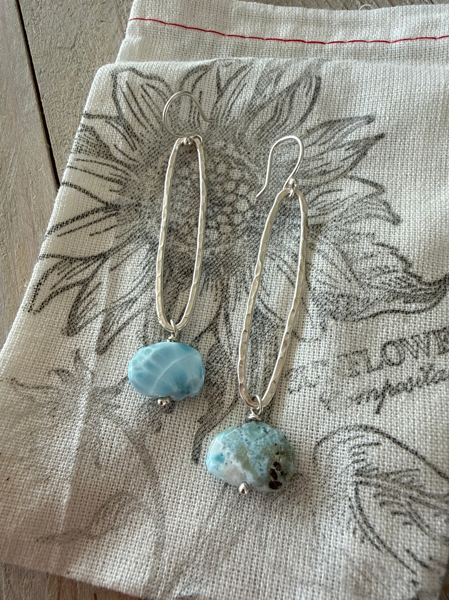 Larimar stones on fine silver elongated oval hoop earrings.