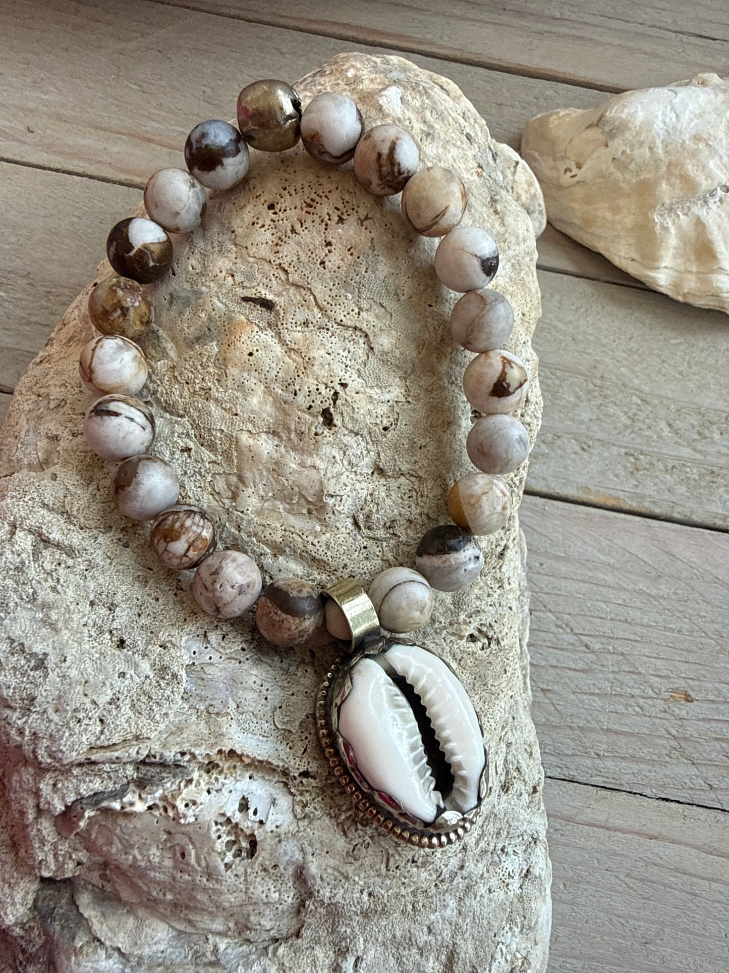 Wood opal and Tibetan cowrie shell charm with repousé back stretch stack bracelet. 6.5-7”