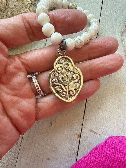 Bone flaming heart pendant on peach blossom agates stretch stack bracelet. 7”.