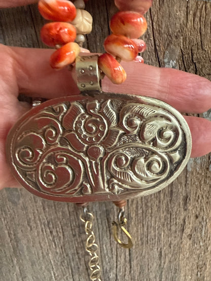 Tibetan carved bone flower pendant on spiny oyster necklace. 16-19”
