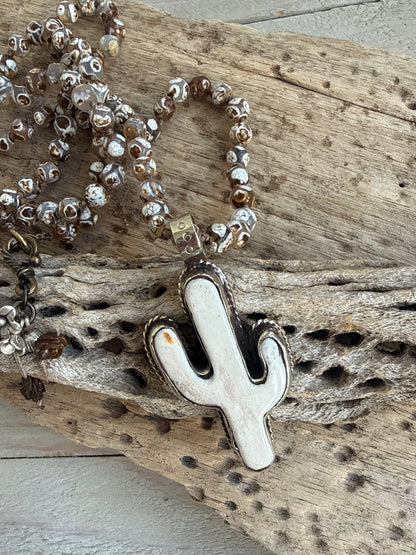 Bone cactus pendant on Dzi agates with fine silver embellishments. 34.5”