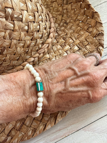White riverstone stretch stack bracelet with turquoise and bone inlay bead from Nepal. 6.5”