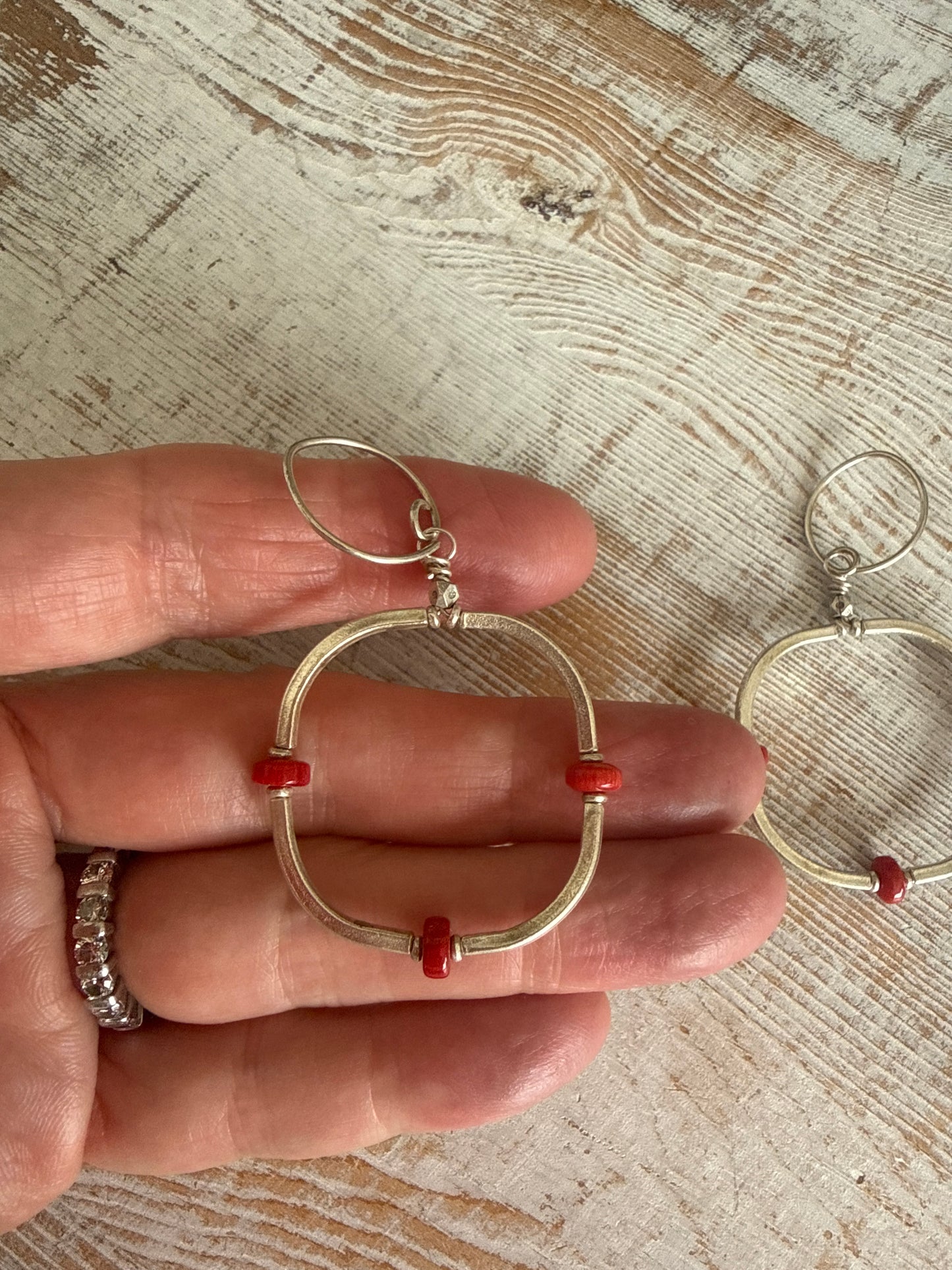 Segmented hoops of fine silver with broom coral accents earrings.