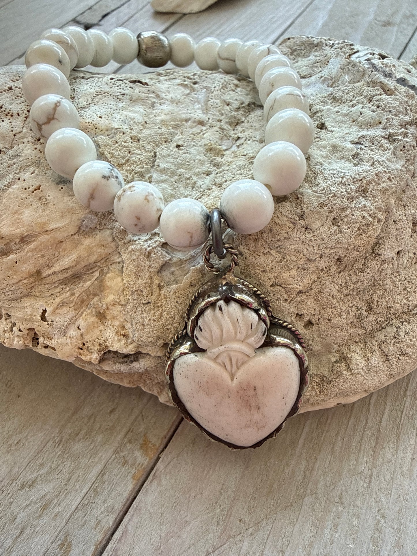Bone flaming heart pendant on peach blossom agates stretch stack bracelet. 7”.