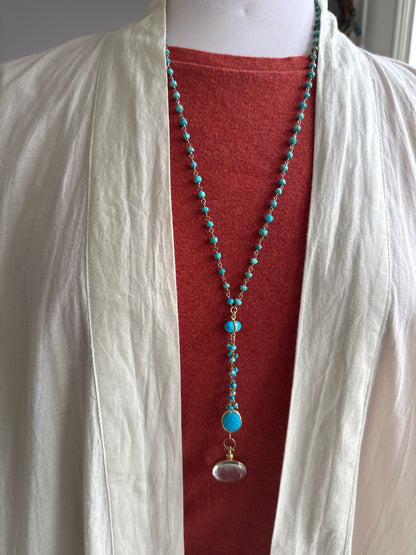 Turquoise rosary style chain with turquoise and gold accent pieces and brass locket necklace.