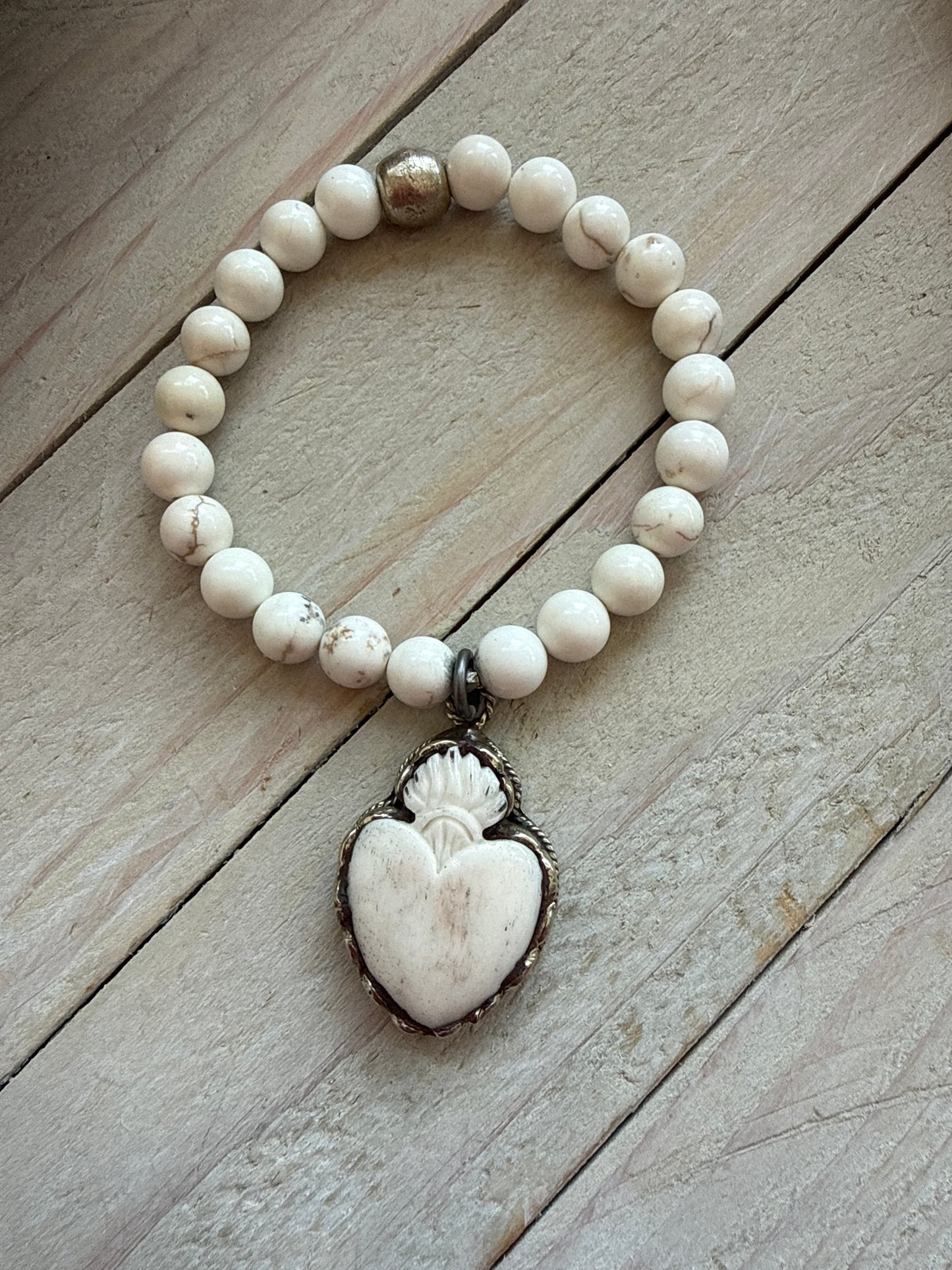 Bone flaming heart pendant on peach blossom agates stretch stack bracelet. 7”.