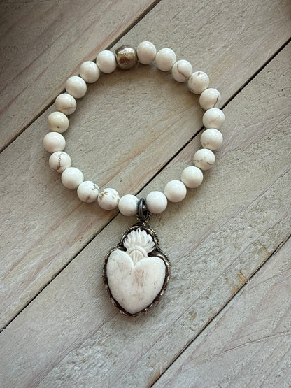 Bone flaming heart pendant on peach blossom agates stretch stack bracelet. 7”.