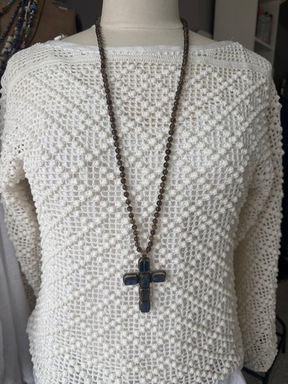 Blue kyanite cross on knotted smoky quartz necklace with fine silver flower accents.