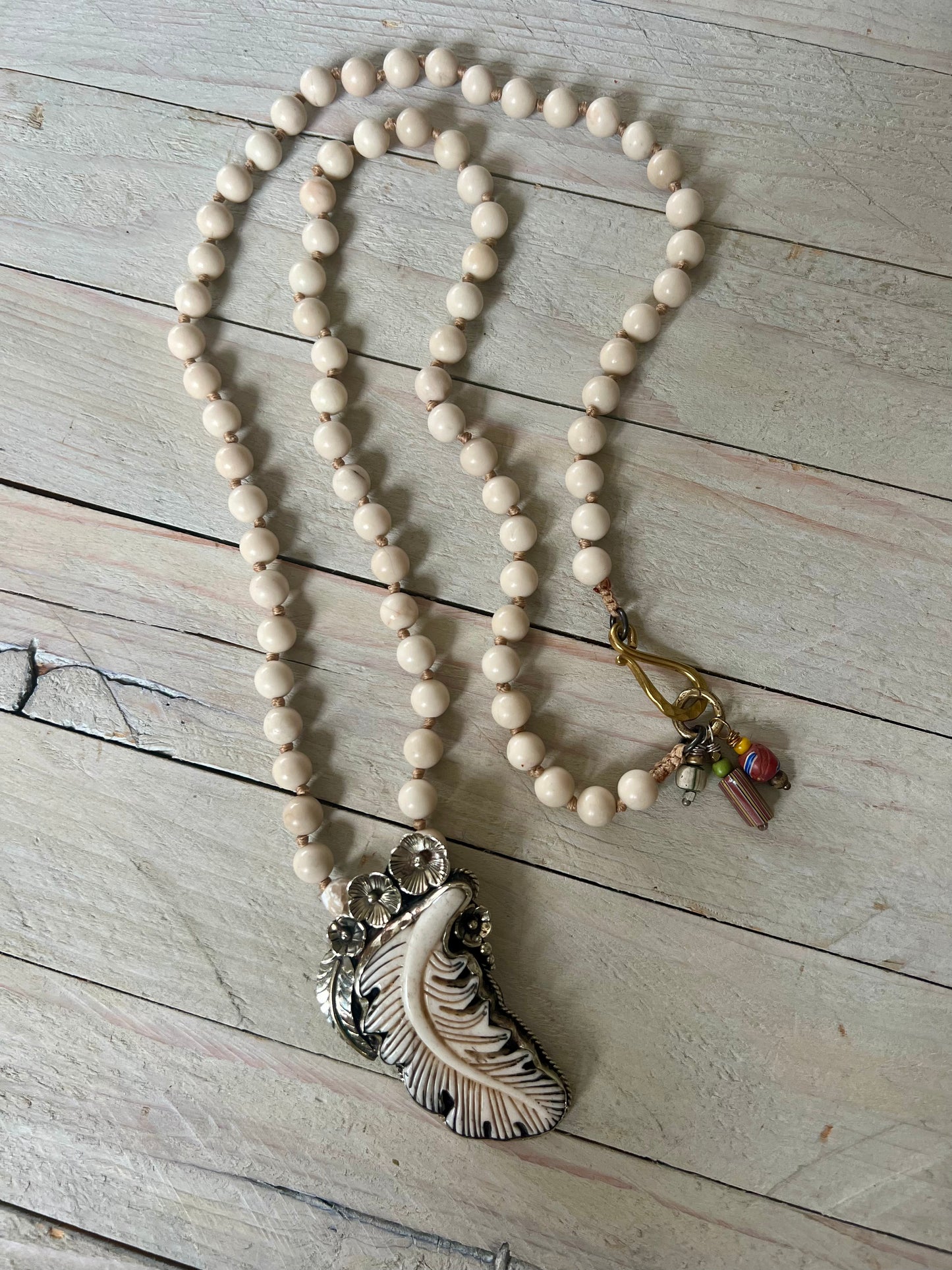 Bone feather on riverstone long boho necklace.