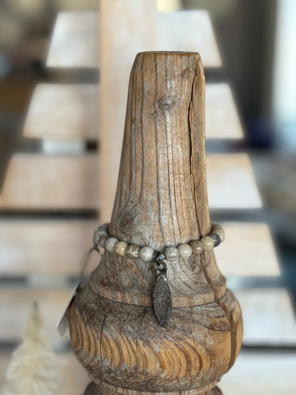 Smoky quartz druzie hangs from a stack bracelet of fossil coral beads 6.5-7”.