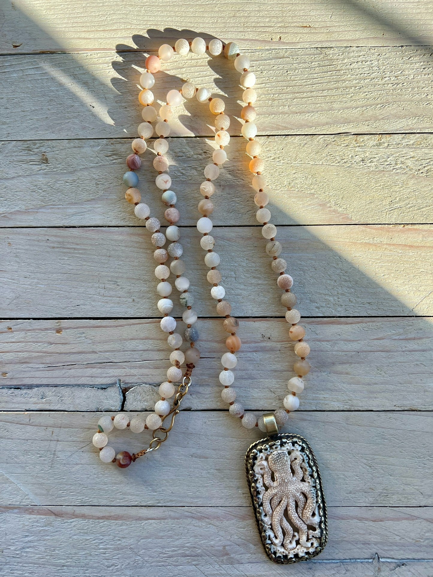 Carved bone octopus on hand-knotted druzy agates.  39” necklace. Wear long or short.