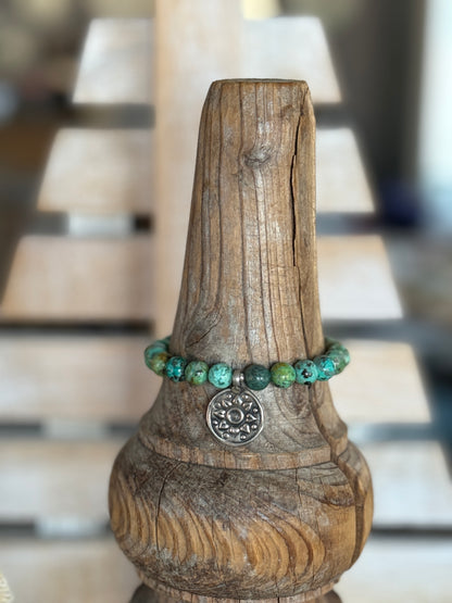 Turquoise beads with a vintage sterling bead and charm stretch bracelet. 6.5-7”