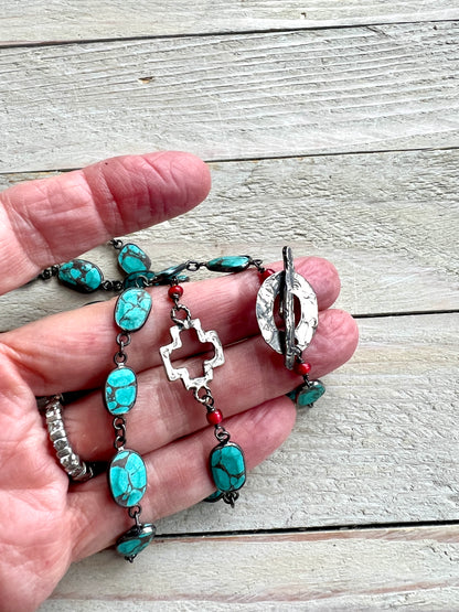 Gorgeous turquoise chain with hand made sterling open cross and toggle. 29”.