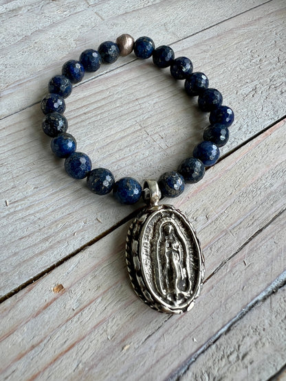 Faceted lapis beads surround a beautiful Tibetan repousé Mary. Stretch stacker bracelet 6-6.5”