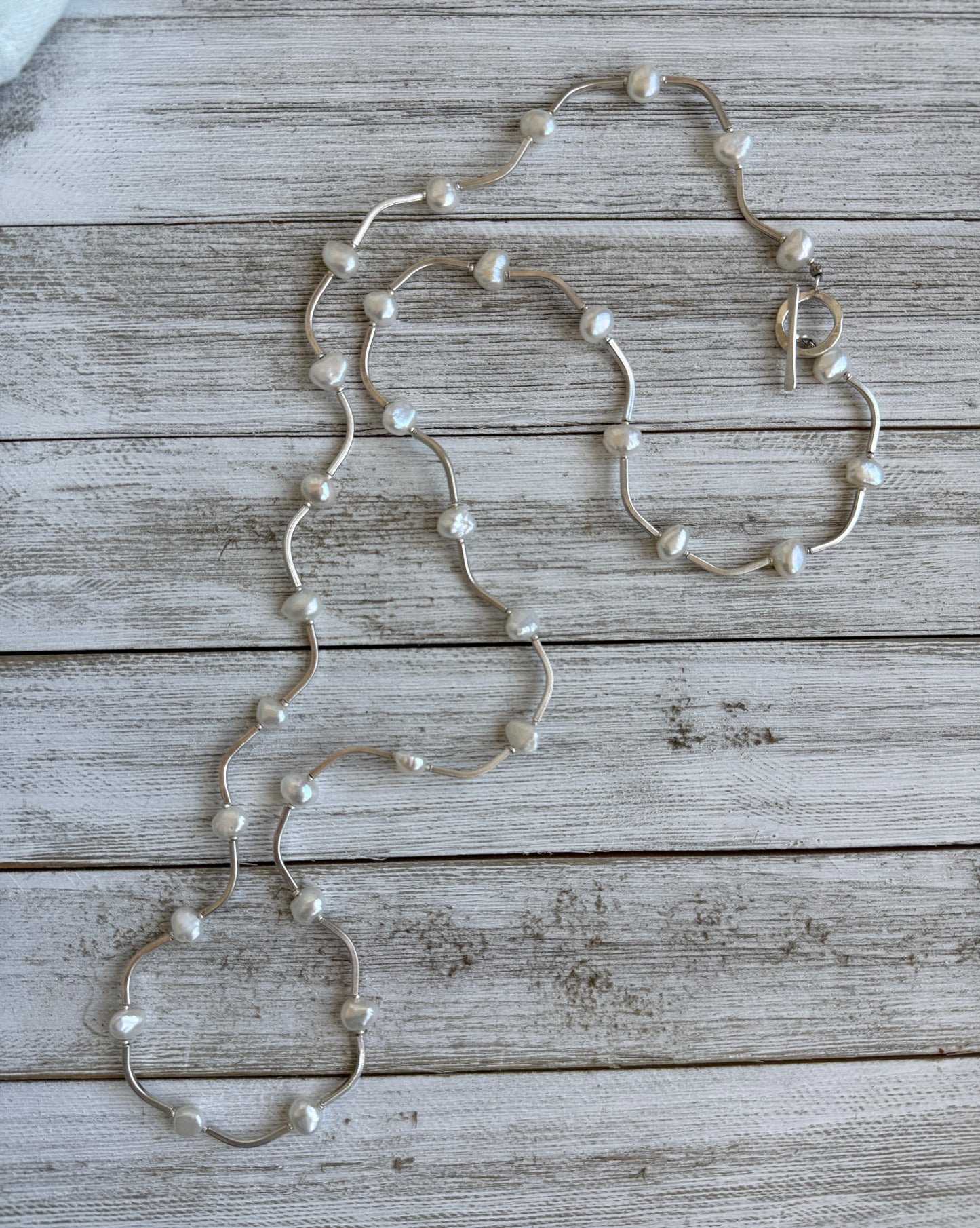 Long fine silver and pearl necklace. 35.75”