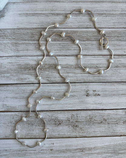 Long fine silver and pearl necklace. 35.75”