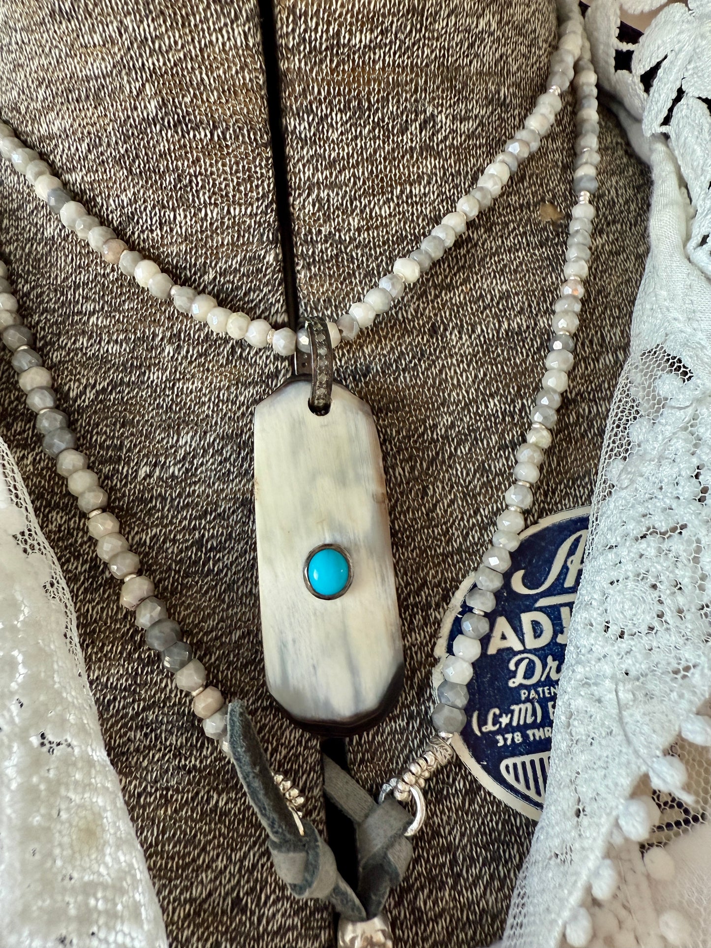 Creamy grey bone pendant with turquoise inlay and diamond bale on silverite and fine silver adjustable necklace.