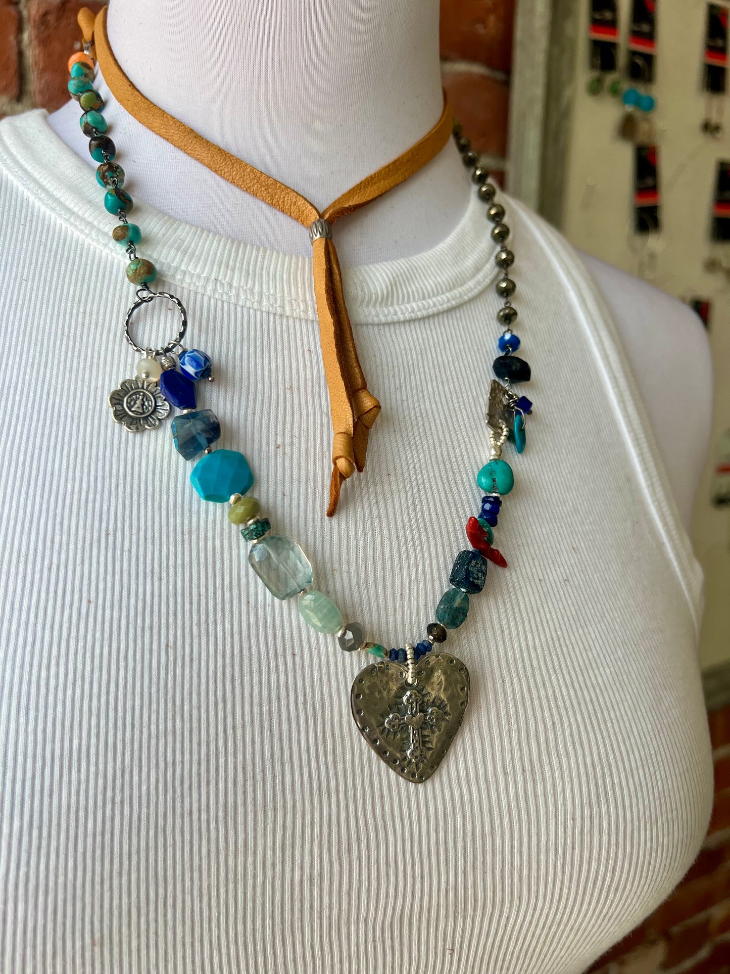 Sterling cross and heart pendant on a colorful assortment of gemstones. Adjustable necklace.