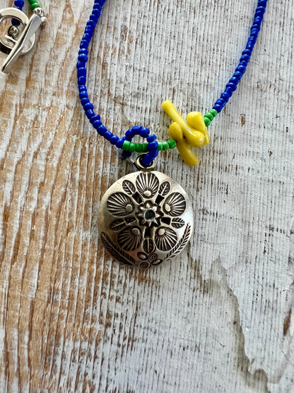 Stamped Thai pendant with colorful Java glass seed beads necklace.