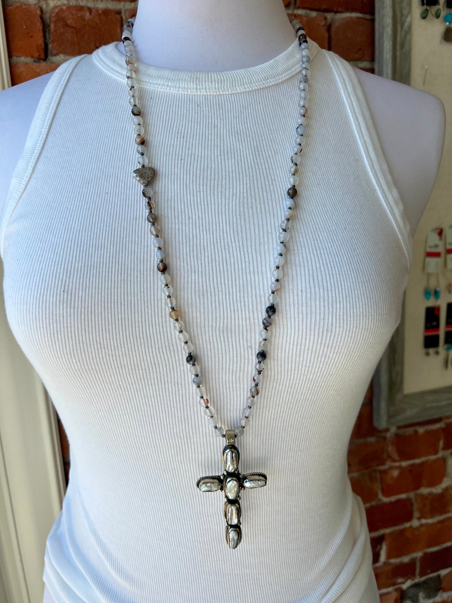 Pearl cross on knotted agates with fine silver heart accent. 44” necklace.