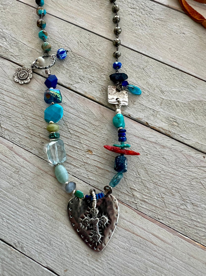 Sterling cross and heart pendant on a colorful assortment of gemstones. Adjustable necklace.