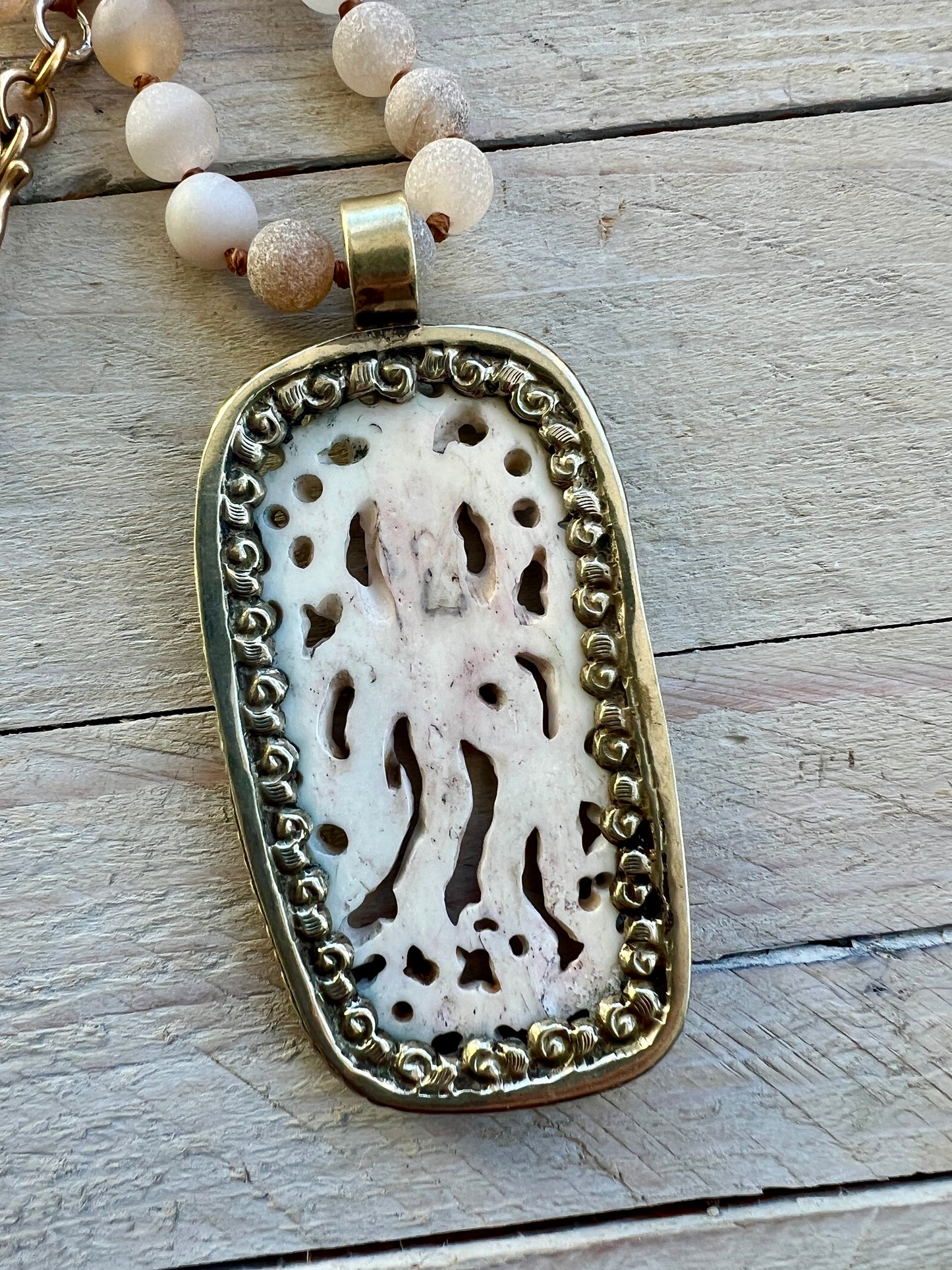 Carved bone octopus on hand-knotted druzy agates.  39” necklace. Wear long or short.