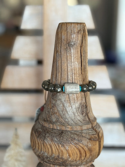 Pyrite beads surround an antler with turquoise accents stretch bracelet. 6.5”